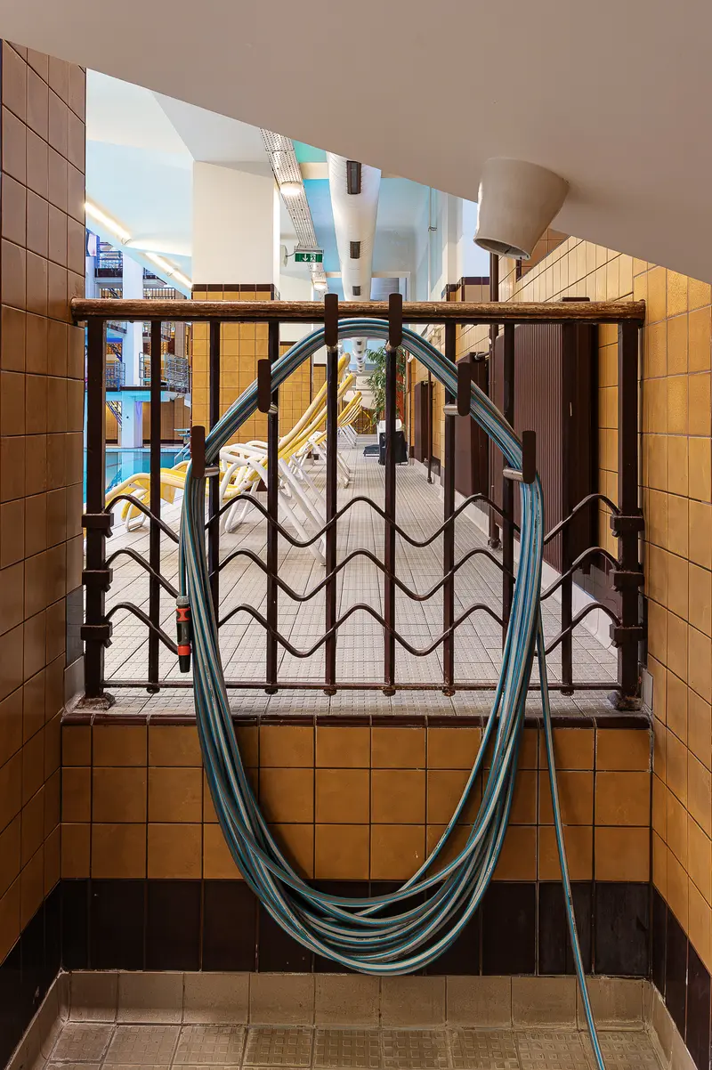 Garden Hose Coiled on Art Deco Iron Railing, Amalienbad Pool Deck Beyond