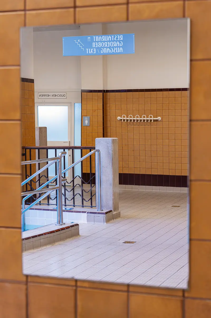 Mirror Reflection of Amalienbad Interior Corridor and Signage