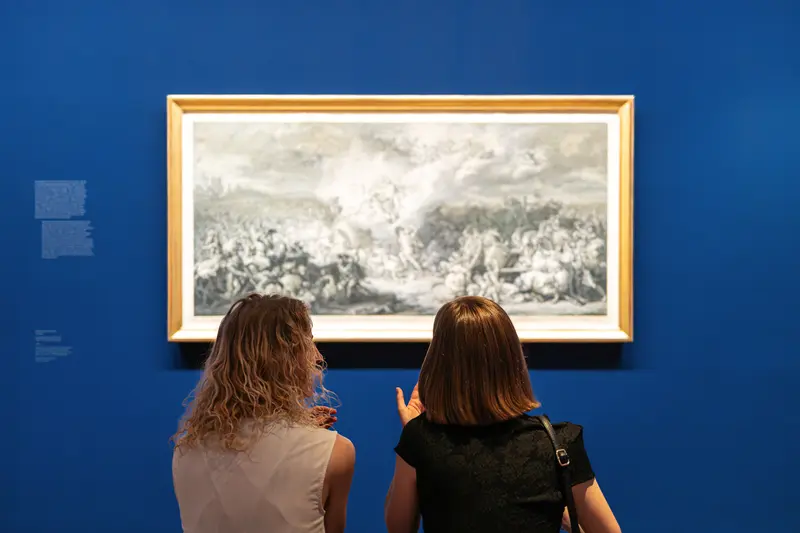 Two Visitors Discussing Large-Scale Drawing on Deep Blue Gallery Wall
