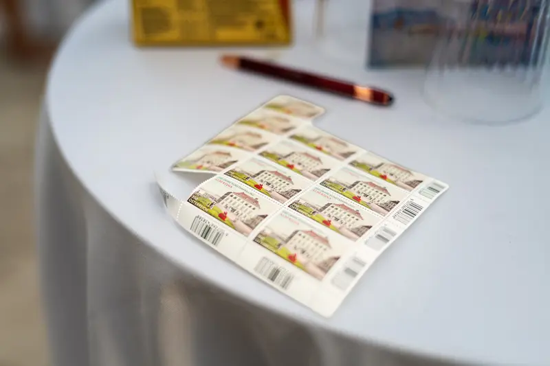Sheet of Commemorative Postage Stamps on White Event Table