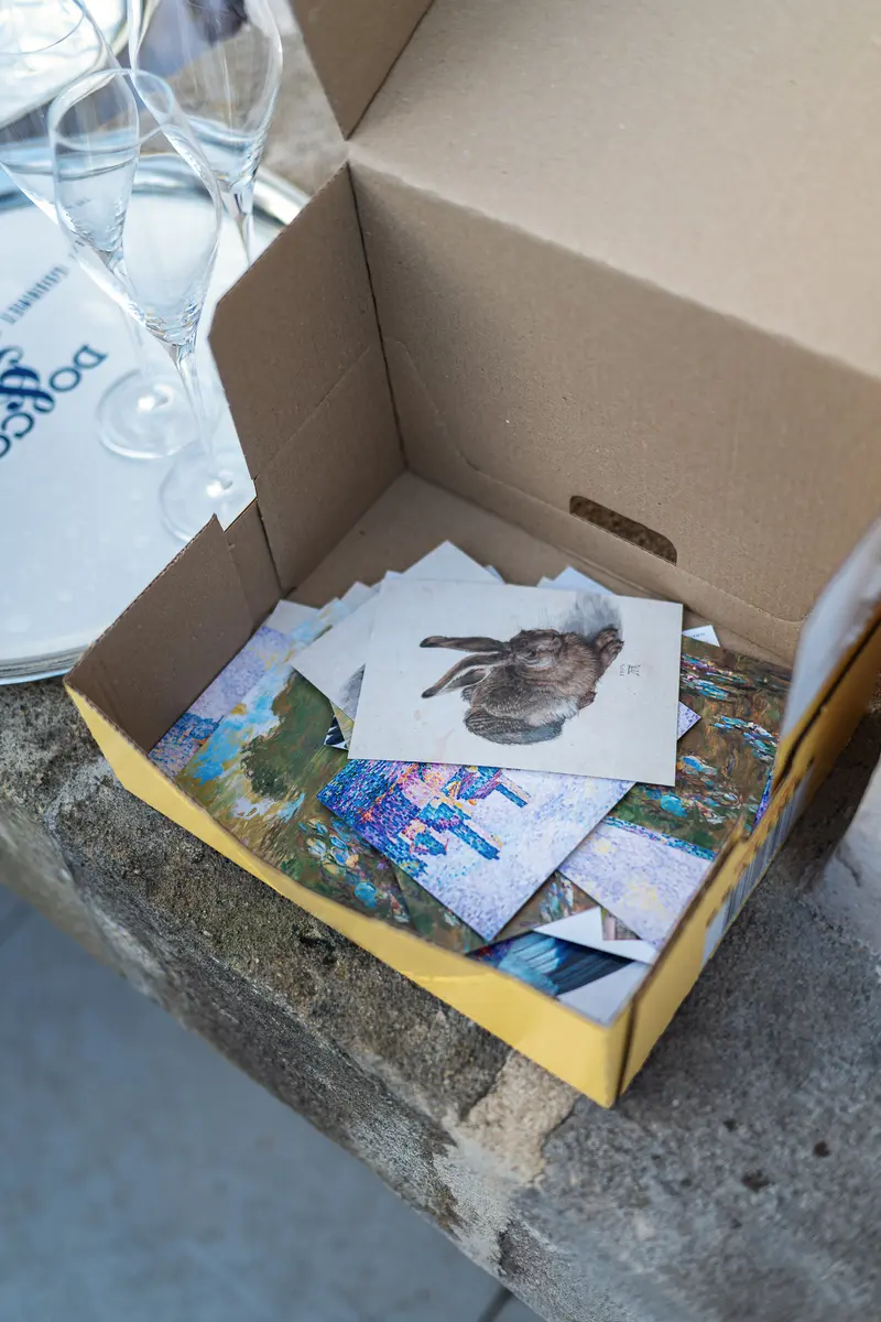Art Postcards in Open Box at Outdoor Event Table