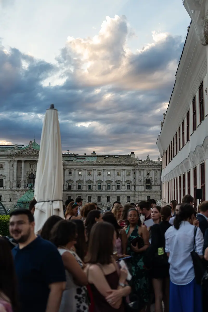 Evening Crowd on Outdoor Terrace with Vienna Kunsthistorisches Museum Backdrop