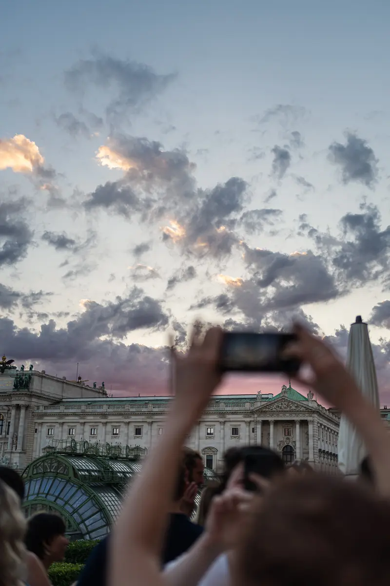 Visitor Photographs Vienna Hofburg Palace at Dusk with Dramatic Sky