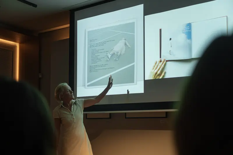 Cig Harvey Points to Projected Book Spread at Leica Gallery Vienna, Sep 29th, 2026