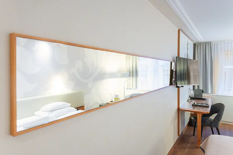 Guest Room Mirror Reflecting Bed and Window at Hotel Das Tigra, Vienna