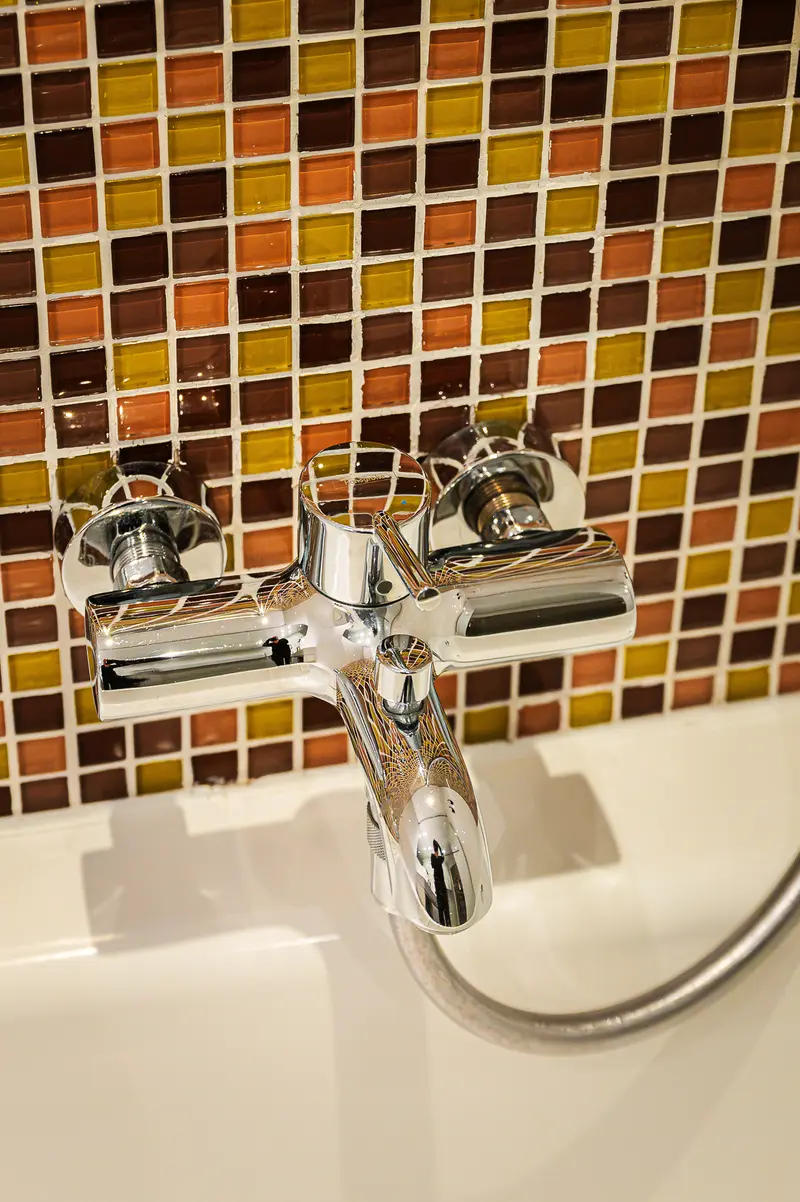 Chrome Bathtub Mixer Tap and Amber Mosaic Tiling, Hotel Das Tigra Vienna