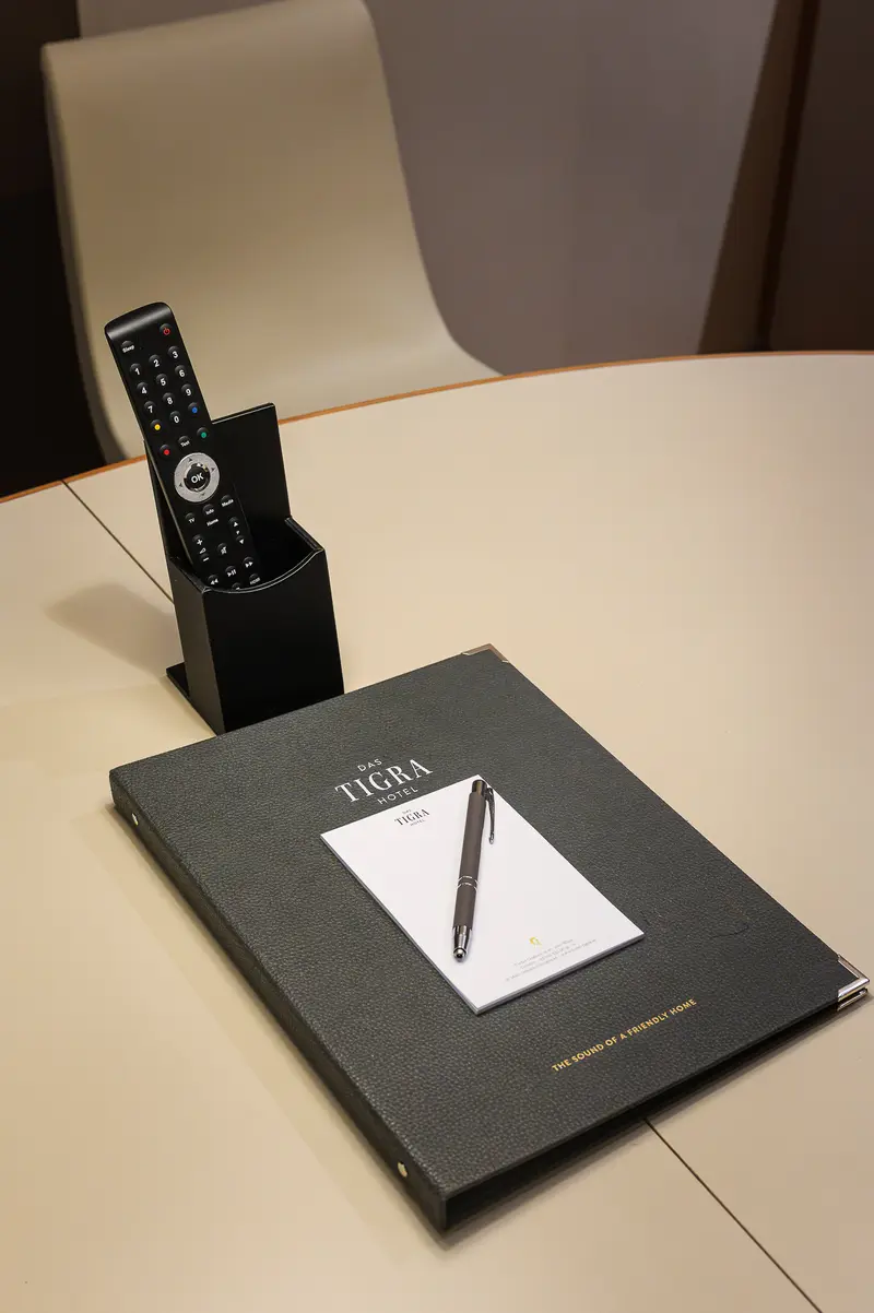 Das Tigra Hotel guest directory, notepad and pen on in-room desk, Vienna