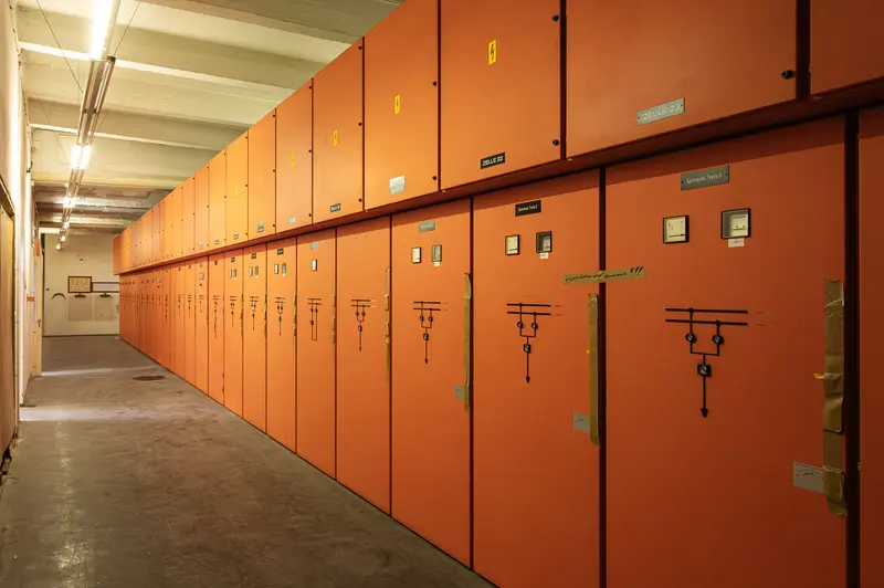 Orange switchgear cabinets in the Glanzstoff St. Pölten substation corridor, Open House 2026