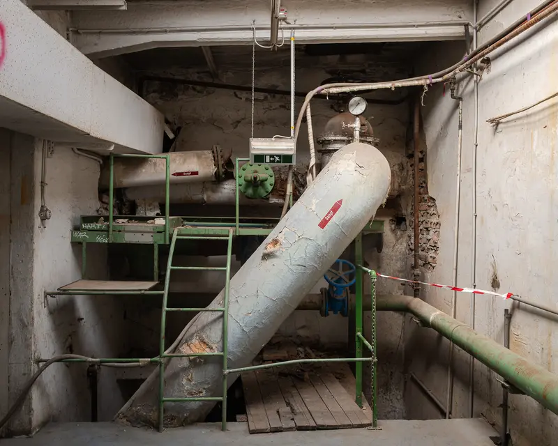 Insulated steam pipe and green access stairs in Glanzstoff St. Pölten boiler room