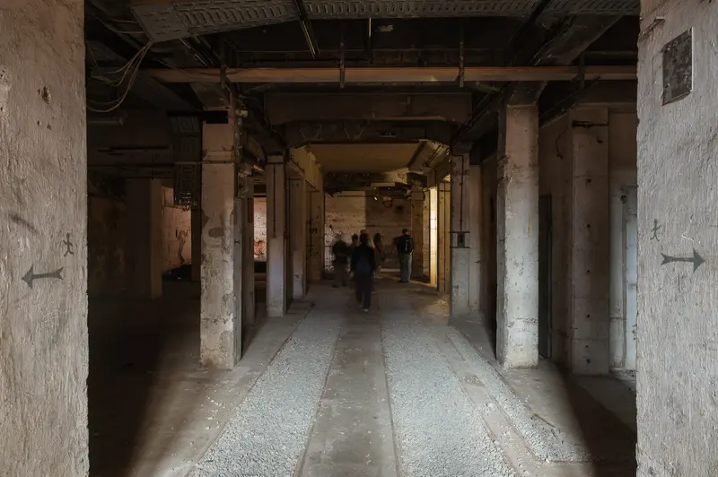 Visitors walking through unlit concrete hall at Glanzstoff St. Pölten Open House 2026