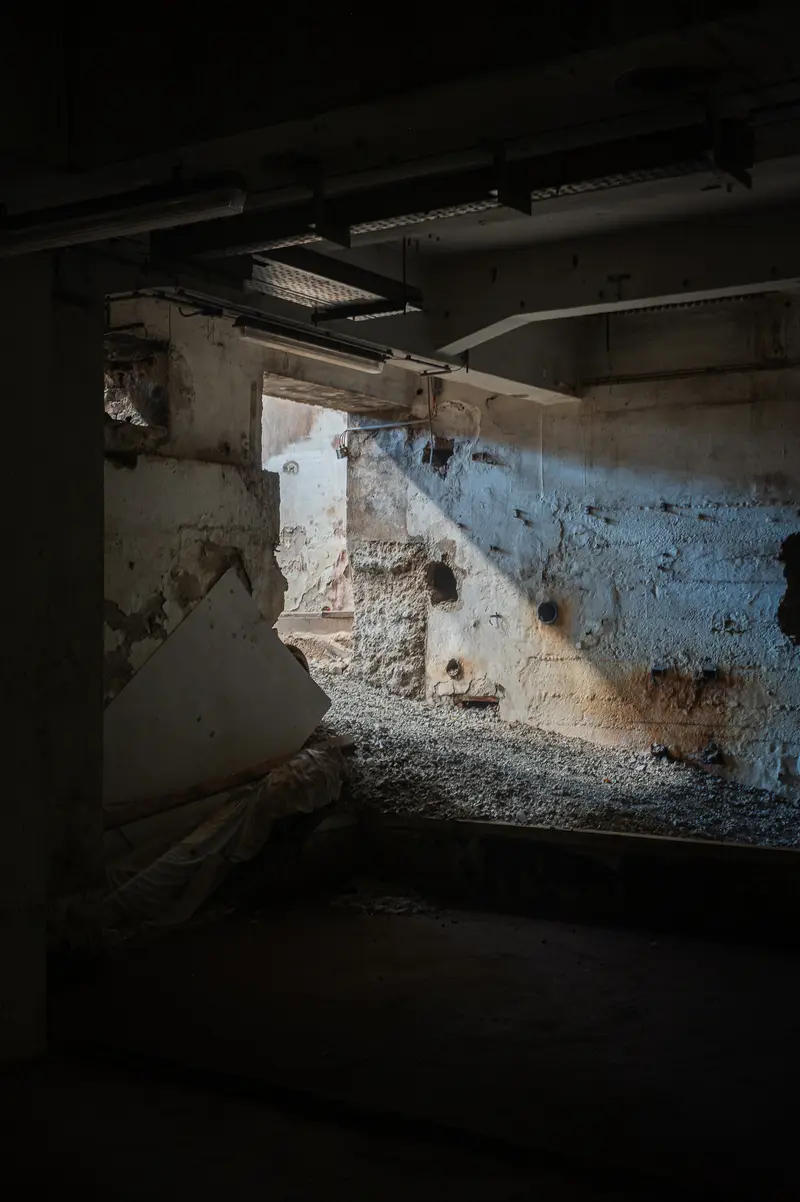 Stripped concrete interior with rubble and exposed conduits, Glanzstoff St. Pölten Open House 2026