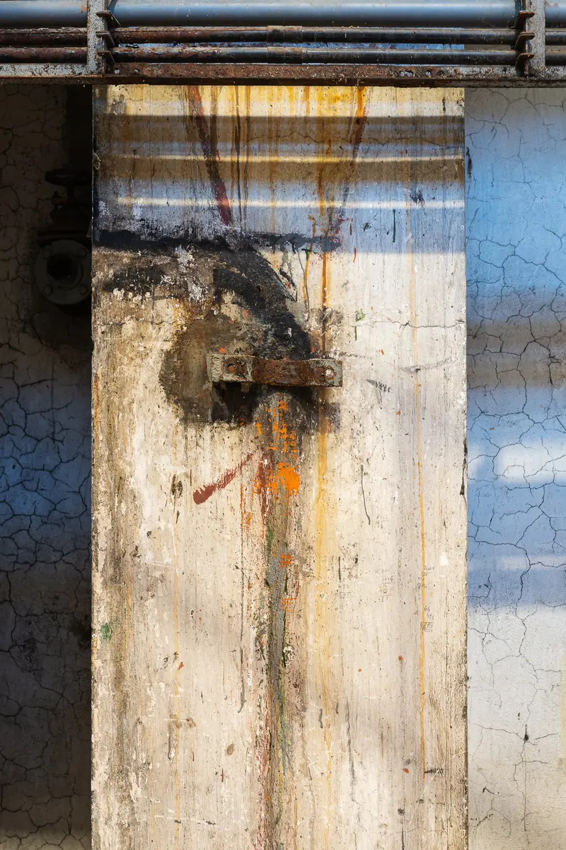 Chemical-stained concrete pillar and rusted bracket at Glanzstoff St. Pölten Open House 2026