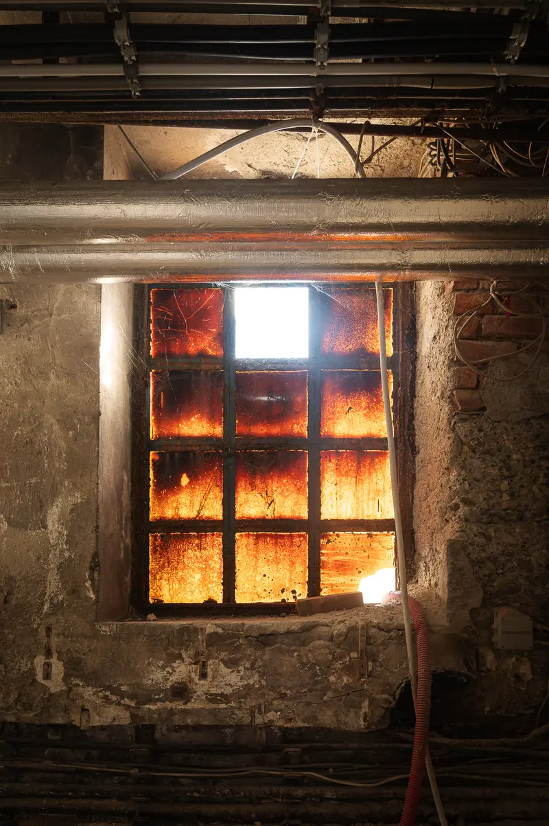 Corroded steel-framed factory window in Glanzstoff St. Pölten industrial hall, Open House 2026