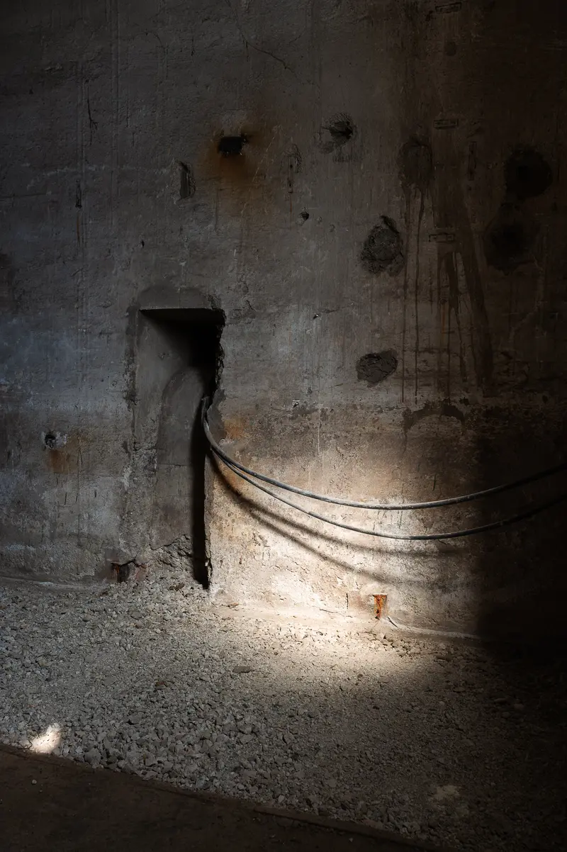 Bare concrete cellar wall and cable run, Glanzstoff St. Pölten Open House 2026