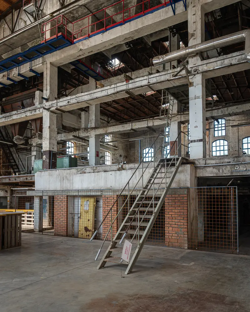 Steel Stair and Multi-Level Concrete Frame Inside Glanzstoff Factory Hall, St. Pölten