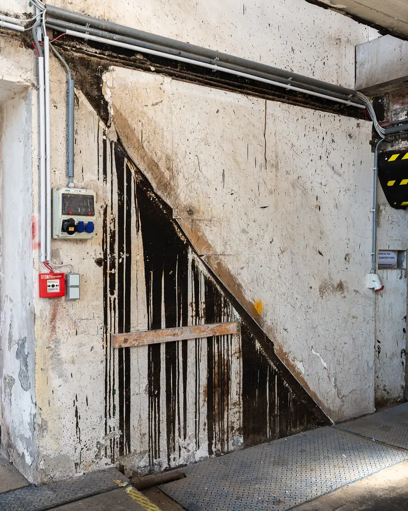 Weathered stairwell wall with fire alarm panel at Glanzstoff St. Pölten Open House 2026