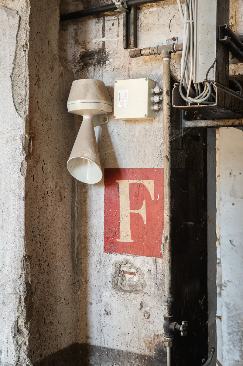 Alarm Horn and Painted Letter "F" on Concrete Wall, Glanzstoff St. Pölten
