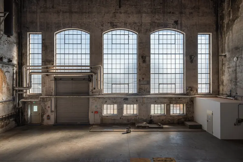 Arched Industrial Windows and Roller Shutter in Glanzstoff St. Pölten Factory Hall