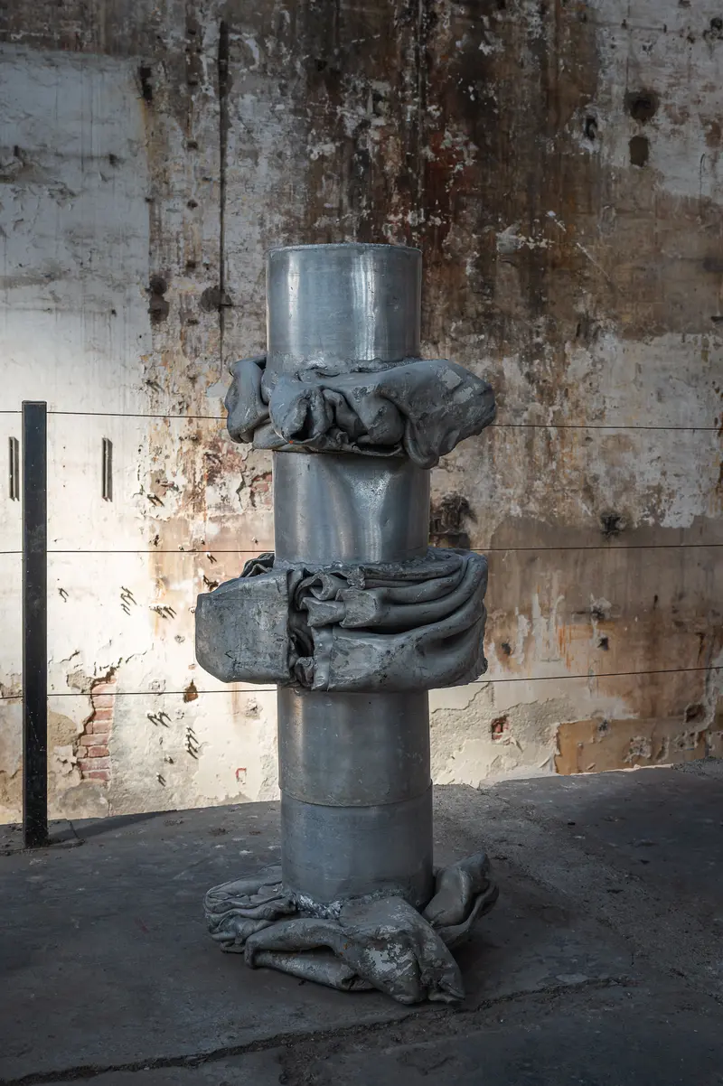 Cast Metal Column Sculpture Against Weathered Concrete Wall, Glanzstoff St. Pölten Open House 2026