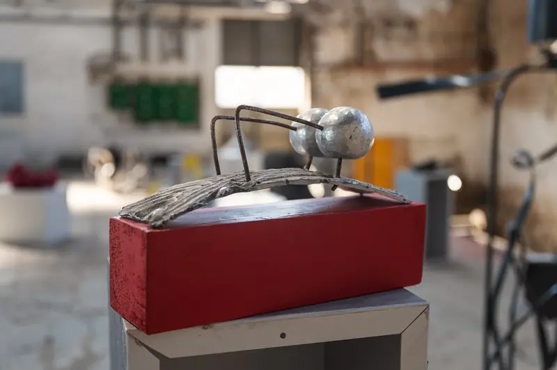 Metal bird sculpture on red plinth inside Glanzstoff factory hall, Open House 2026