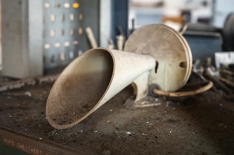 Dust-covered factory siren horn on workbench at Glanzstoff St. Pölten Open House 2026