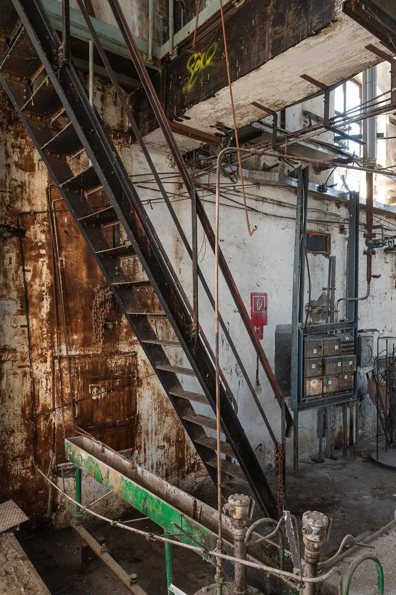 Rusted steel staircase and electrical panels inside Glanzstoff factory hall, St. Pölten