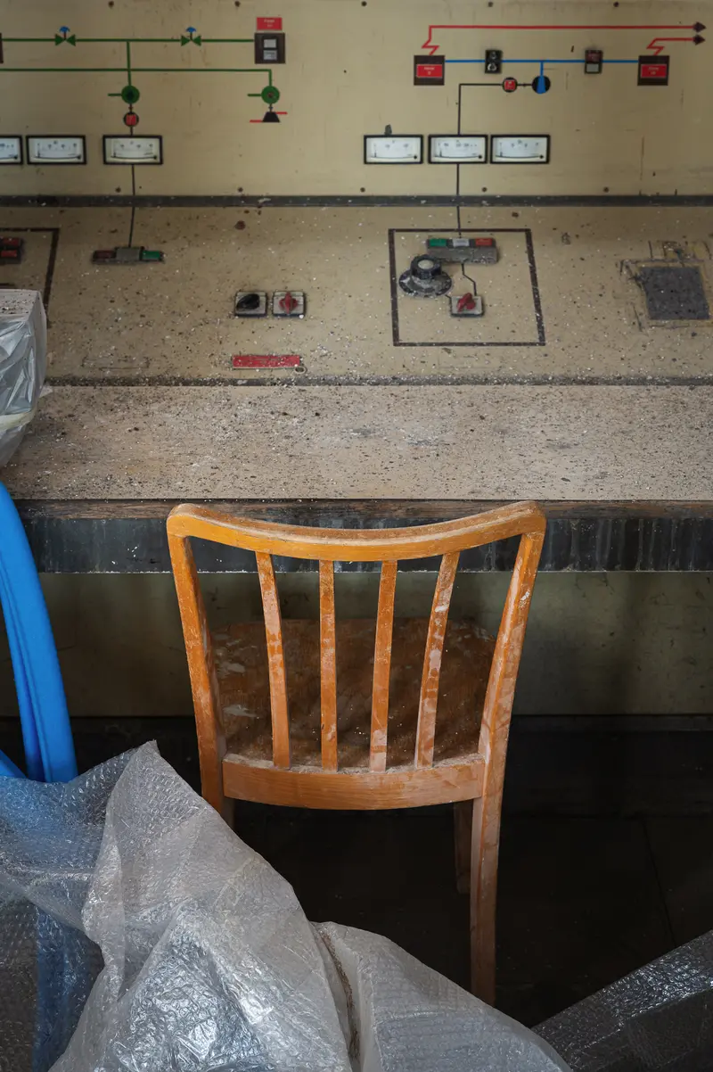 Historic control desk with mimic diagram and wooden chair at Glanzstoff St. Pölten