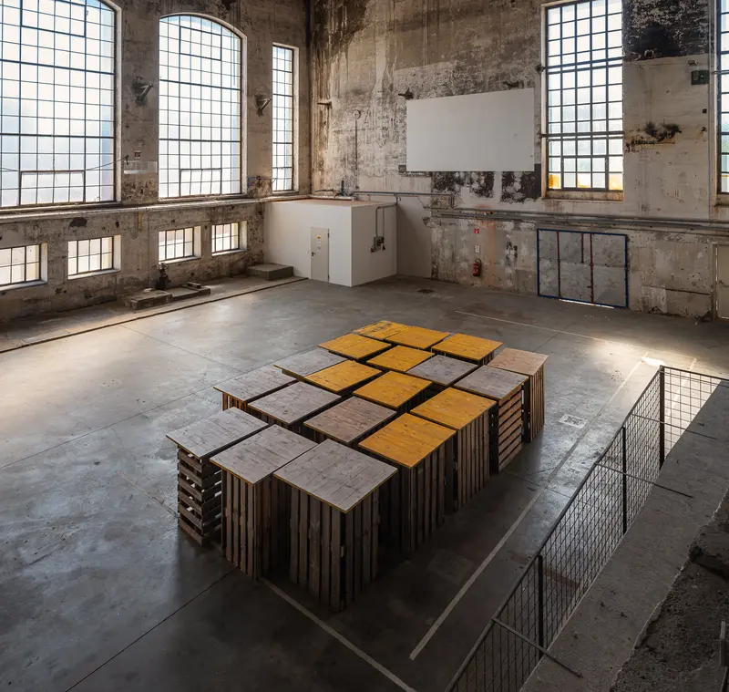 Grid of Stacked Wooden Pallet Platforms in Glanzstoff Factory Hall, St. Pölten