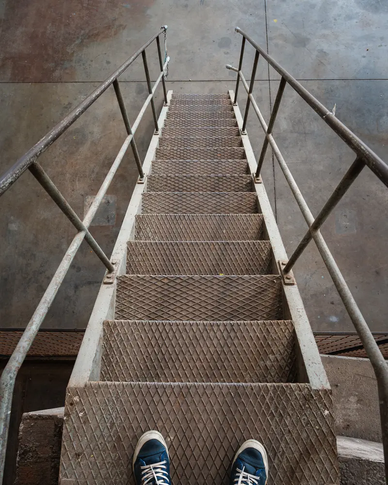 Rusted industrial steel staircase with expanded-metal treads, Glanzstoff St. Pölten Open House 2026
