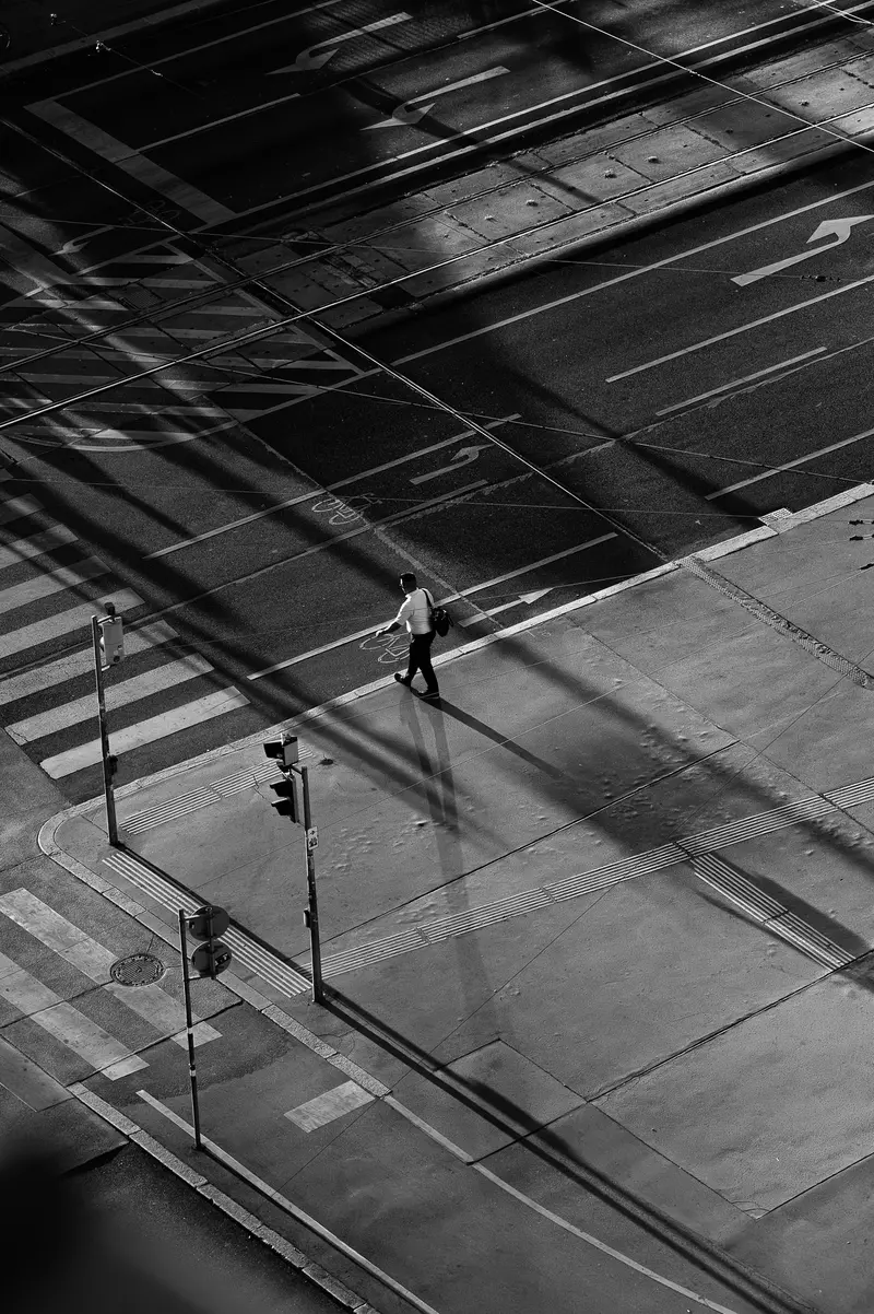 Lone pedestrian crossing empty Vienna intersection during the 12 August 2026 solar eclipse