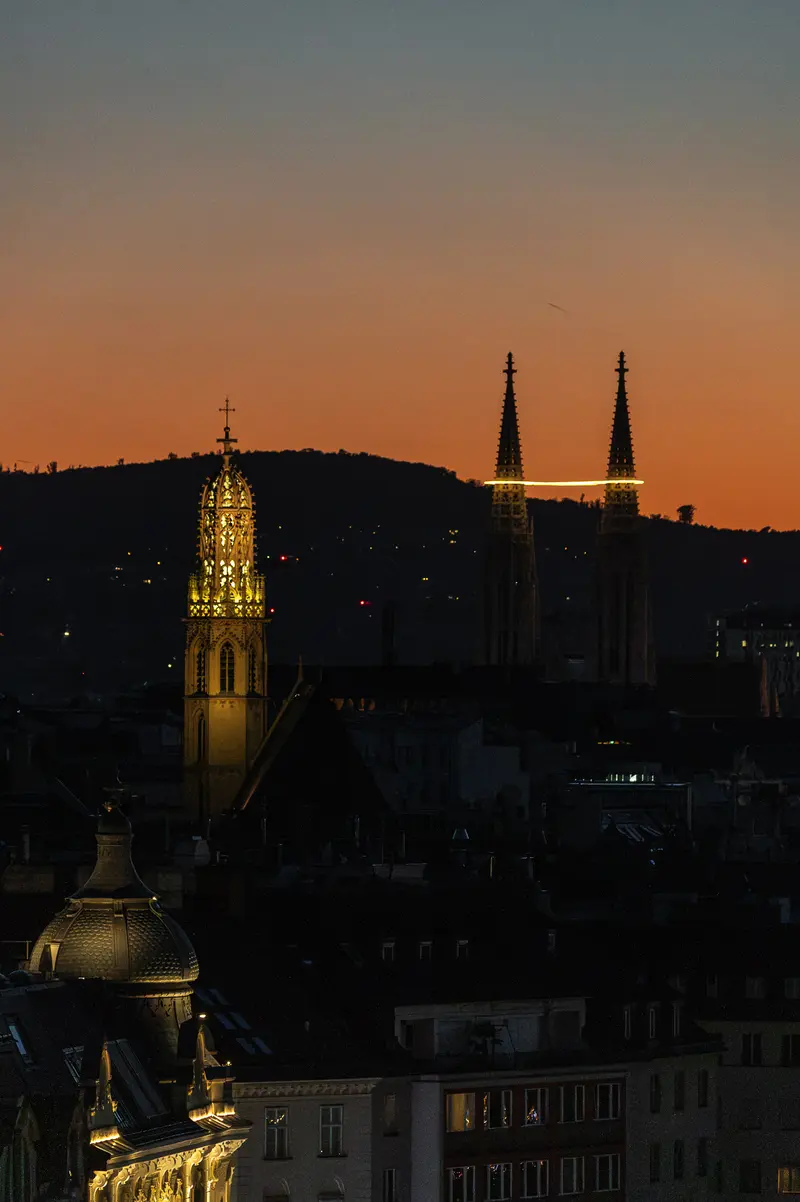 Rathaus Tower and Votivkirche Spires Above Vienna After the 2026 Total Solar Eclipse