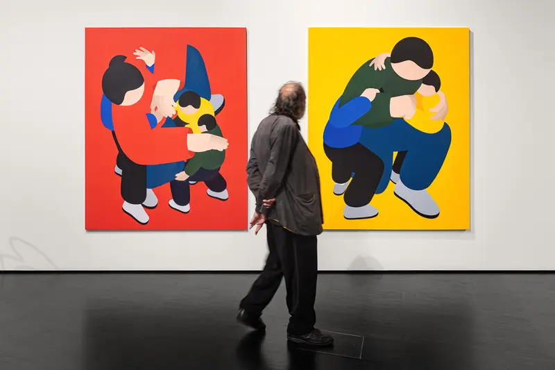 Visitor Viewing Marko Sajn's Red and Yellow Paintings at Strabag Art Site Opening